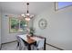 Bright dining room featuring a modern chandelier, natural light, and neutral decor at 7877 W 110Th Dr, Westminster, CO 80021