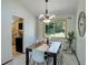 Cozy dining room with view of the backyard, modern lighting, and access to kitchen at 7877 W 110Th Dr, Westminster, CO 80021