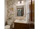 Half-bath featuring tiled accent wall, wood cabinet, and sink at 7877 W 110Th Dr, Westminster, CO 80021
