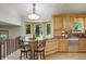 Kitchen nook features a breakfast bar with stone countertop, wood cabinets and window overlooking yard at 7877 W 110Th Dr, Westminster, CO 80021