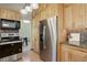 This kitchen features custom wood cabinets, granite counters, tile backsplash, and stainless appliances at 7877 W 110Th Dr, Westminster, CO 80021