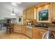 Charming kitchen with wooden cabinets, granite countertops, and stainless steel appliances at 7877 W 110Th Dr, Westminster, CO 80021