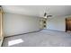 Bright living room with plush carpeting, large windows, and a ceiling fan at 7877 W 110Th Dr, Westminster, CO 80021