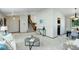 Spacious living area with hardwood floors, access to staircase, and modern decor at 7877 W 110Th Dr, Westminster, CO 80021