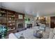 Bright living room features a brick fireplace and built-in bookcase with views through to the eat-in kitchen at 7877 W 110Th Dr, Westminster, CO 80021