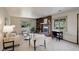 Open living room featuring a brick fireplace, custom built-in bookcase and bright windows at 7877 W 110Th Dr, Westminster, CO 80021
