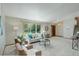 Comfortable living room with large window, plush seating, and staircase access at 7877 W 110Th Dr, Westminster, CO 80021