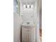 Bright bathroom featuring a vessel sink with cabinet and modern lighting at 253 N Lincoln St, Denver, CO 80203
