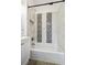 Modern bathroom featuring tiled shower and bathtub, neutral paint, and recessed shelf at 253 N Lincoln St, Denver, CO 80203