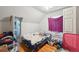 A simple bedroom with a window, access to a bathroom, and light colored walls at 253 N Lincoln St, Denver, CO 80203