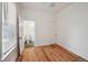 Bedroom with wood floors and ensuite bathroom with neutral paint and natural light at 253 N Lincoln St, Denver, CO 80203
