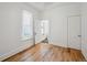 Bright bedroom with wood floors and ensuite bath featuring neutral paint and trim at 253 N Lincoln St, Denver, CO 80203