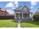 Charming gray two-story home with a welcoming front porch and a well-maintained front yard at 253 N Lincoln St, Denver, CO 80203