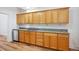Traditional kitchen featuring wooden cabinets, granite countertops, and stainless steel dishwasher at 253 N Lincoln St, Denver, CO 80203