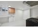 A compact kitchen features bright white walls and a modern gas range at 253 N Lincoln St, Denver, CO 80203