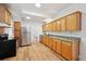 Well-equipped kitchen with stainless steel refrigerator, wood cabinets, and granite countertops at 253 N Lincoln St, Denver, CO 80203