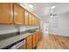 Functional kitchen featuring wood cabinets, granite counters, and modern appliances at 253 N Lincoln St, Denver, CO 80203