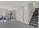 Finished basement featuring fitness equipment, stairs and a large storage closet at 20928 E Hamilton Ave, Aurora, CO 80013