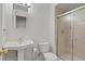 Bathroom featuring a pedestal sink, toilet, and glass-enclosed shower at 20928 E Hamilton Ave, Aurora, CO 80013