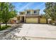 Inviting two-story home with brick accents, covered porch, and a large driveway for ample parking at 20928 E Hamilton Ave, Aurora, CO 80013