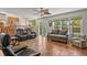 Open-concept living room with hardwood floors, comfortable seating, and an easy transition to the kitchen at 20928 E Hamilton Ave, Aurora, CO 80013