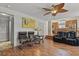 Cozy living room features wood floors, stylish furnishings, and an open layout with kitchen access at 20928 E Hamilton Ave, Aurora, CO 80013