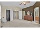Spacious primary bedroom has nice natural lighting, neutral carpet, and an attached bath at 20928 E Hamilton Ave, Aurora, CO 80013