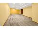 Spacious basement area with neutral carpet, yellow walls and recessed lighting at 7655 S Olive Cir, Centennial, CO 80112