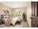 Well-lit bedroom features neutral tones, a plant, an accent rug, and a window with outdoor views at 7655 S Olive Cir, Centennial, CO 80112