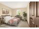 Well-lit bedroom featuring neutral tones, an accent rug, and a window with outdoor views at 7655 S Olive Cir, Centennial, CO 80112