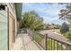 Spacious deck with wooden railings, overlooking a quiet street surrounded by mature trees and landscaping at 7655 S Olive Cir, Centennial, CO 80112