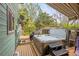 Outdoor hot tub on a wooden deck with privacy fencing and overhead awning for shade and relaxation at 7655 S Olive Cir, Centennial, CO 80112