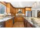Gourmet kitchen with granite counters, stainless steel appliances, and custom cabinetry at 7655 S Olive Cir, Centennial, CO 80112