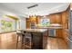 Bright kitchen featuring wood cabinets, a granite-topped island, and stainless steel appliances at 7655 S Olive Cir, Centennial, CO 80112
