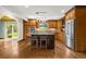 Bright kitchen featuring wood cabinets, a granite-topped island, and stainless steel appliances at 7655 S Olive Cir, Centennial, CO 80112