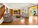 Living room featuring hardwood floors, a brick fireplace, and plenty of natural light at 7655 S Olive Cir, Centennial, CO 80112