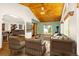 Comfortable living room with wood-paneled ceiling, gas fireplace and backyard views at 7655 S Olive Cir, Centennial, CO 80112