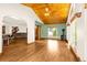 Open concept living area with hardwood floors, wooden ceiling, a ceiling fan, and large windows for natural light at 7655 S Olive Cir, Centennial, CO 80112