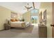Bright main bedroom with vaulted ceiling, ceiling fan, balcony access, and neutral decor at 7655 S Olive Cir, Centennial, CO 80112