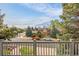 Street view of a well-maintained home with mature trees and landscaping from an elevated angle at 7655 S Olive Cir, Centennial, CO 80112