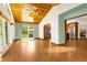 Bright sunroom with hardwood floors, a wooden ceiling, and large windows offering views of the backyard and kitchen at 7655 S Olive Cir, Centennial, CO 80112