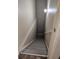 Stairway leading to the basement with gray steps and handrail at 5131 Delphinium Cir, Brighton, CO 80601