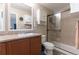 Bathroom featuring a shower with glass door, sink, and storage space above the toilet at 5131 Delphinium Cir, Brighton, CO 80601