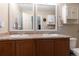 Bathroom featuring double sinks with dark wood cabinets and plenty of vanity space at 5131 Delphinium Cir, Brighton, CO 80601