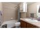 Bright bathroom with combination shower and tub with decorative tiled walls at 5131 Delphinium Cir, Brighton, CO 80601