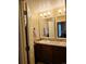 Bathroom with double sink, vanity, and bright lighting at 5131 Delphinium Cir, Brighton, CO 80601