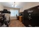 Bedroom with a safe, desk, and exercise equipment, providing versatile options for work, security, and fitness at 5131 Delphinium Cir, Brighton, CO 80601