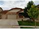Charming single-Gathering home with a two-car garage, stone accents, and a cozy front porch at 5131 Delphinium Cir, Brighton, CO 80601