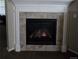 Close up of fireplace with decorative tile surround and white mantel at 5131 Delphinium Cir, Brighton, CO 80601
