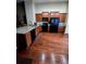 Well-lit kitchen with granite countertops, stainless steel appliances, and hardwood floors at 5131 Delphinium Cir, Brighton, CO 80601